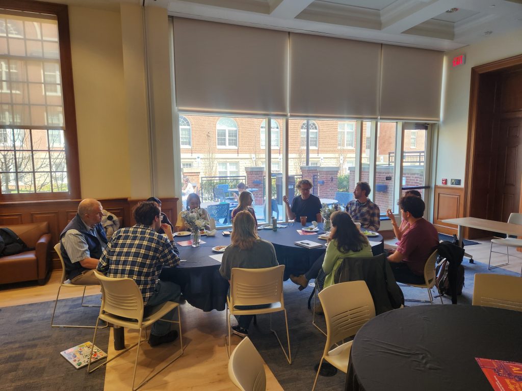 Chris and Sam discussing audio production with students and faculty